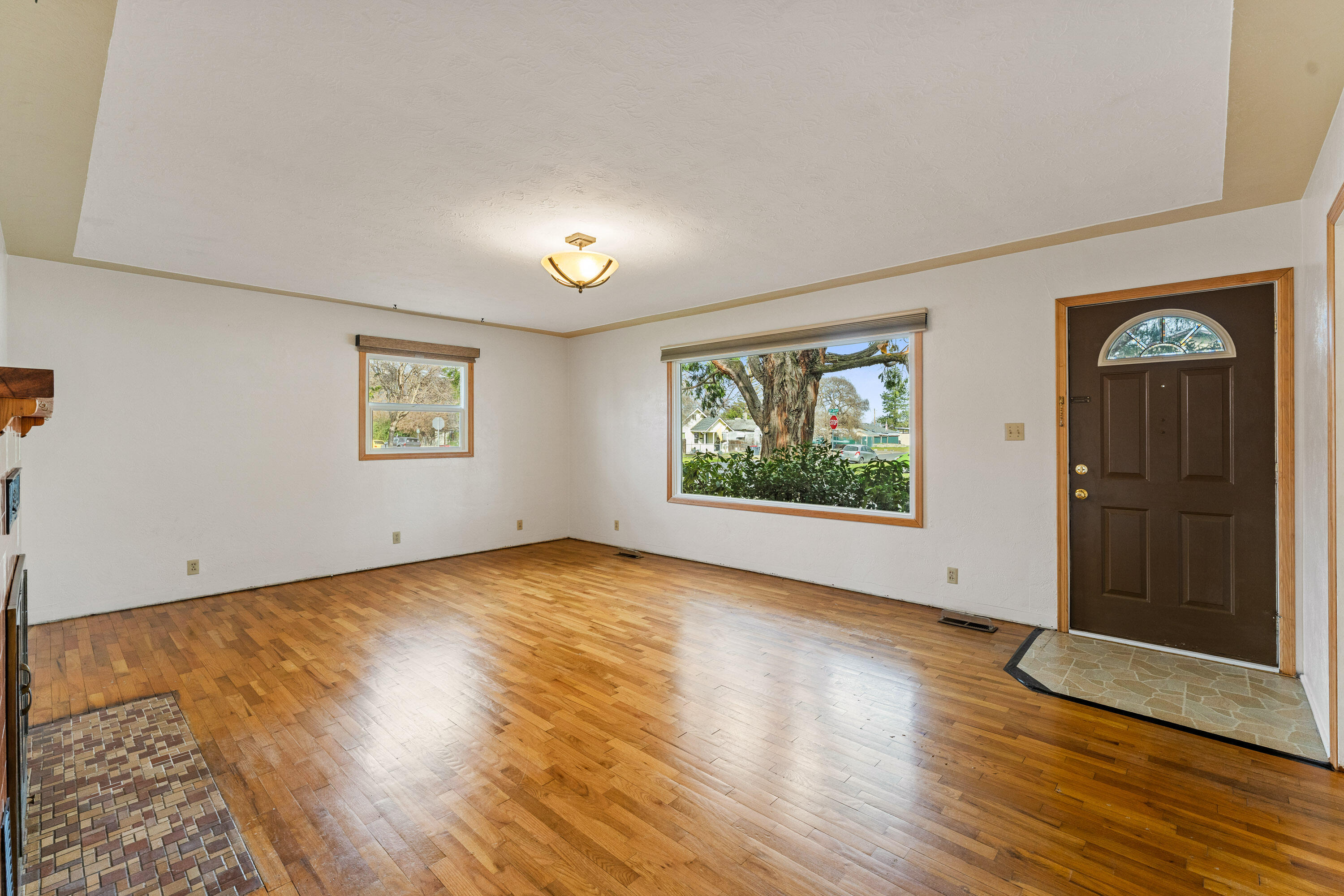 220 South 3rd Street Central Point, OR 97502 - Photo 7 of 29 Living room with beautiful picture window to old growth trees.