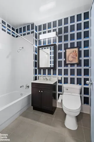 a bathroom with a toilet a sink and shower
