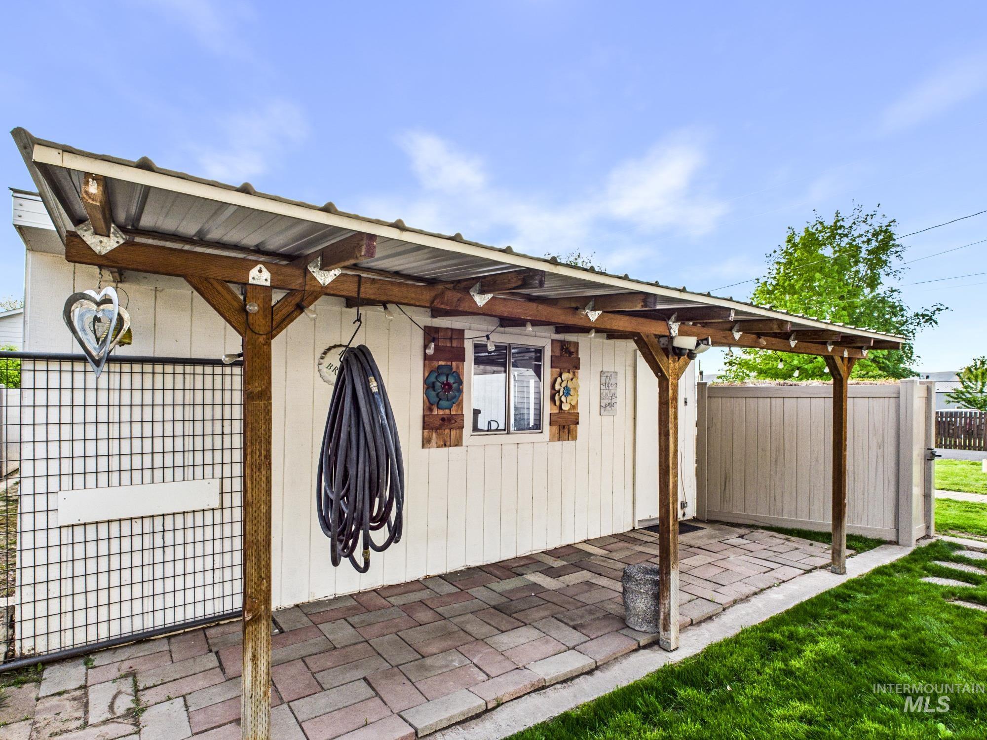 3422 6th Street Lewiston, ID 83501 - Photo 32 of 43 Covered patio featuring a corrugated metal roof supported by wood posts