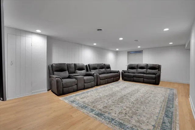 a living room with furniture a couch and a flat screen tv