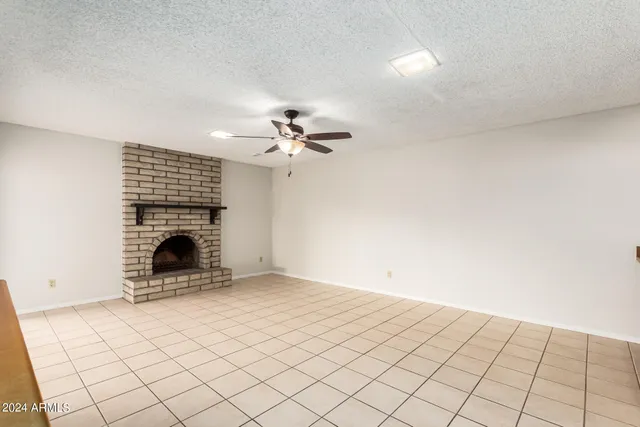 a view of an empty room with a fireplace