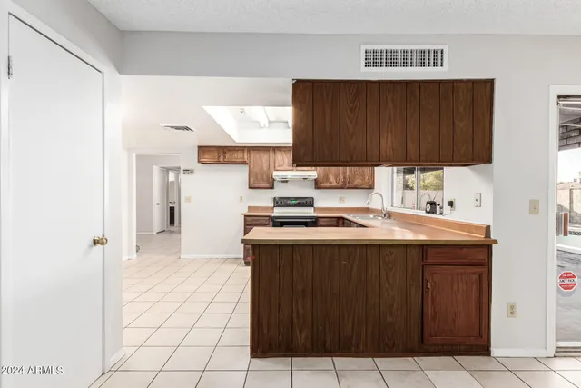 a kitchen with a cabinets and a stove top oven