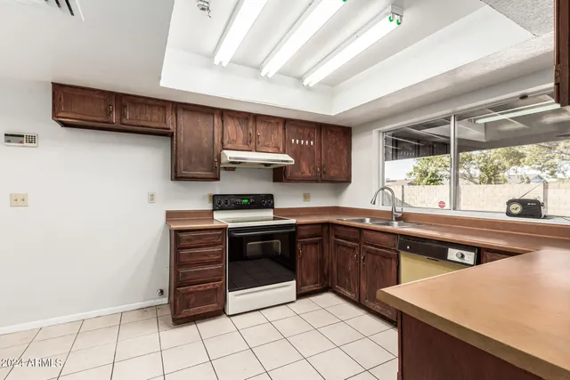 a kitchen with stainless steel appliances a sink stove and cabinets