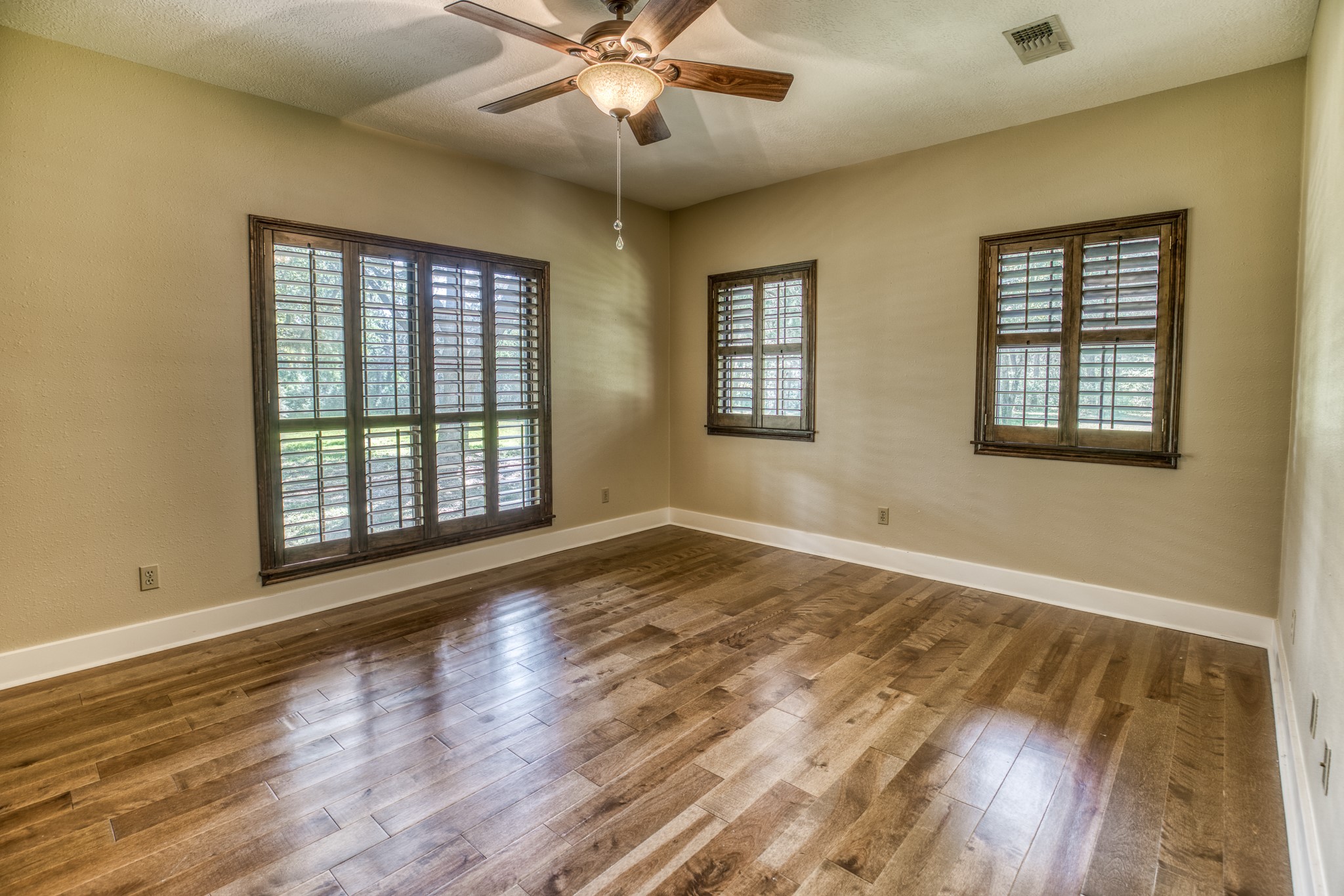 1017 Allen Road Cat Spring, TX 78933 - Photo 18 of 47 a view of an empty room with wooden floor and a window