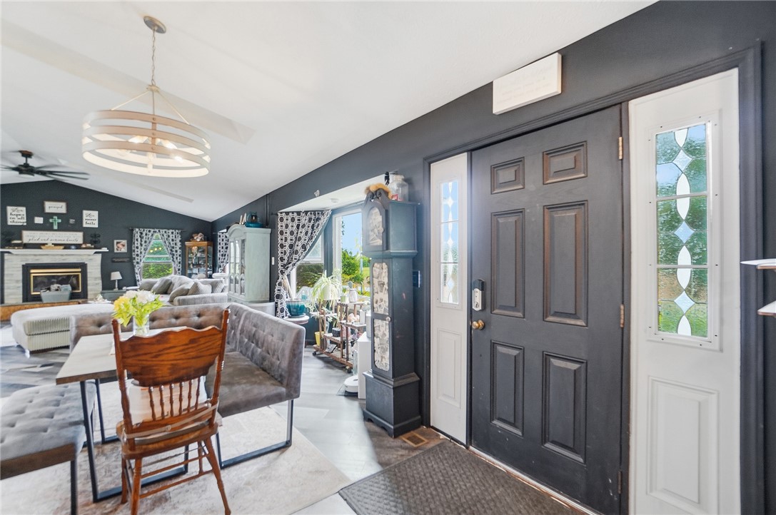 5209 North Addison New Carlisle Road St. Paris, OH 43072 - Photo 5 of 47 This inviting interior features a striking fireplace and vaulted ceilings, creating an open and airy living space.