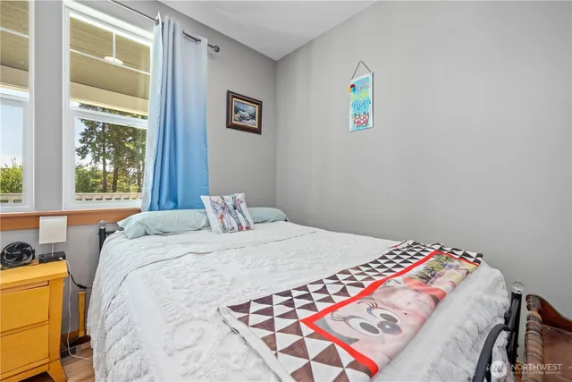 a bedroom with a bed and a window