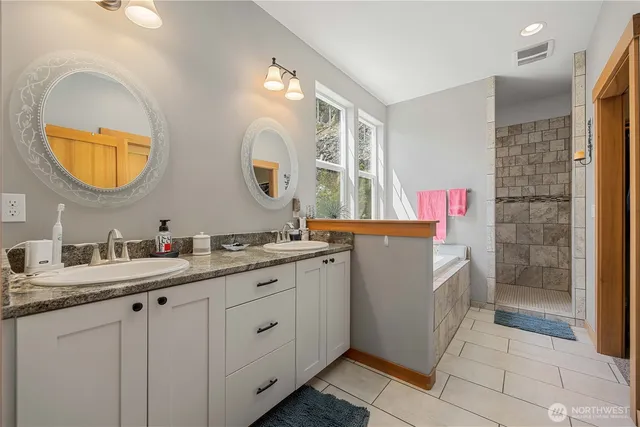 a bathroom with a granite countertop sink mirror and double