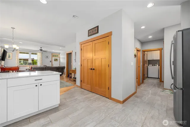 a view of a hallway with wooden floor and a living room