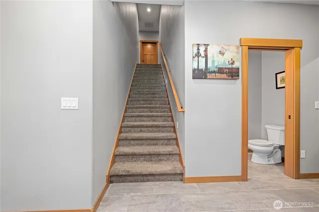a view of a hallway with wooden floor and entryway