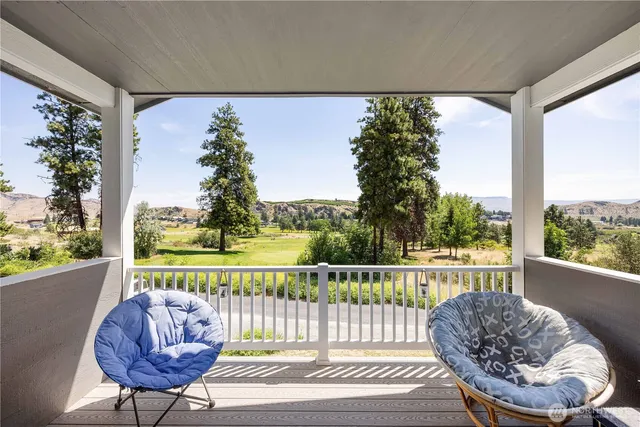 a view of a chair and table in the balcony