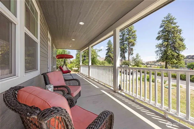 a balcony with furniture and garden view