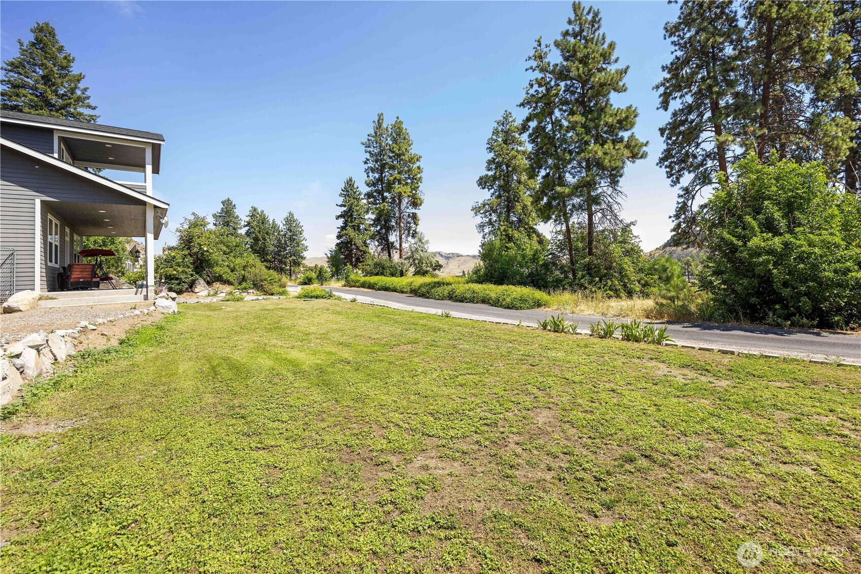 48 Golf Course Drive Pateros, WA 98846 - Photo 35 of 37 a view of a large pool with lawn chairs under an umbrella