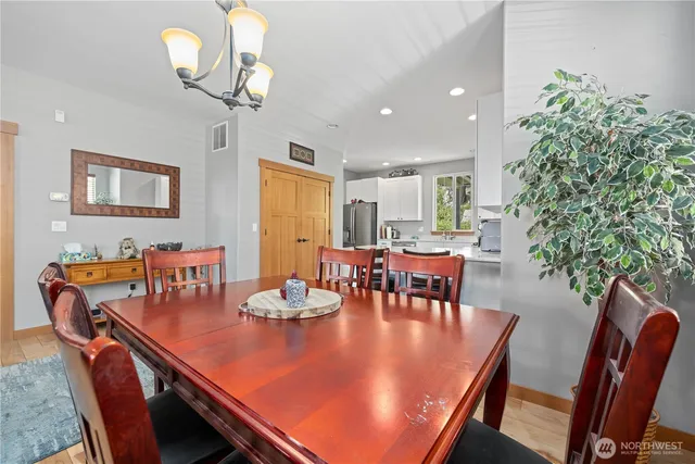 a view of a dining room with furniture and chandelier