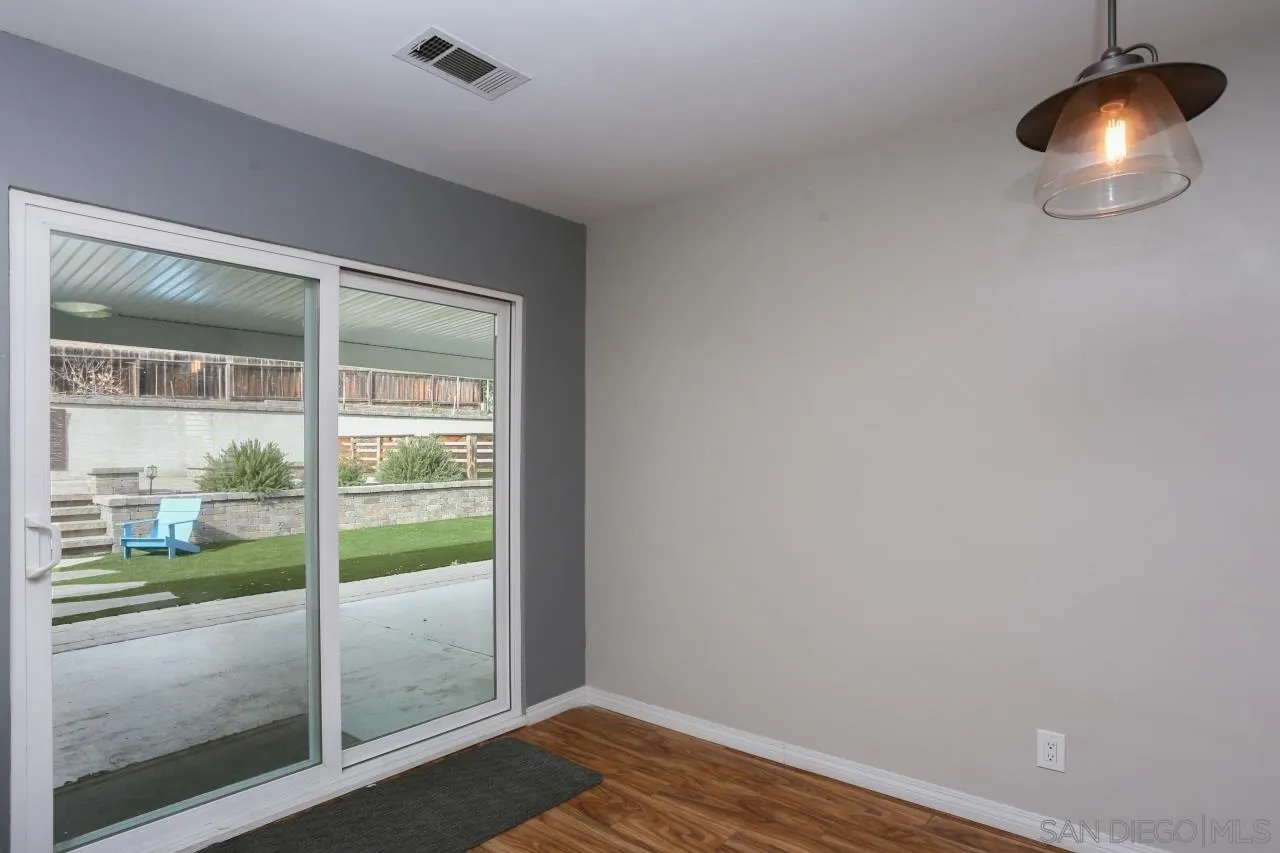 1229 Rees Road Escondido, CA 92026 - Photo 17 of 44 a view of an empty room with wooden floor and a window