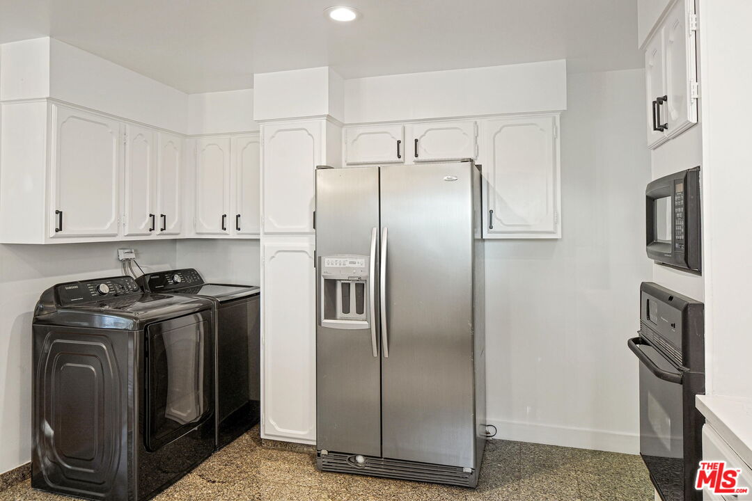 1102 Maple Street Santa Monica, CA 90405 - Photo 19 of 51 a metallic refrigerator freezer sitting inside of a kitchen