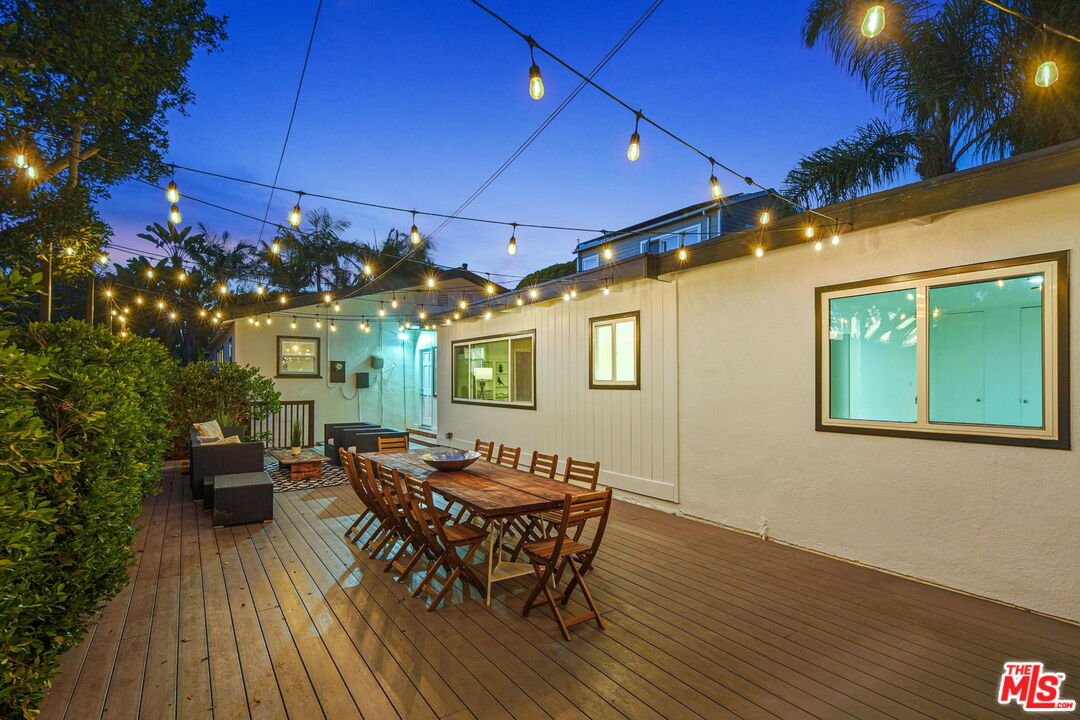 1102 Maple Street Santa Monica, CA 90405 - Photo 51 of 51 a view of a patio with table and chairs with wooden floor and fence