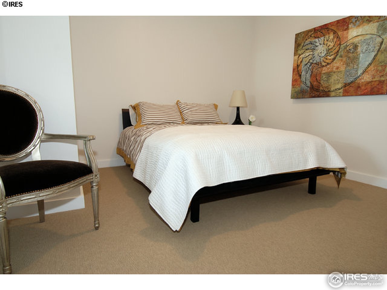 1655 Walnut Street, Unit 305 Boulder, CO 80302 - Photo 18 of 25 a bedroom with a bed and chair