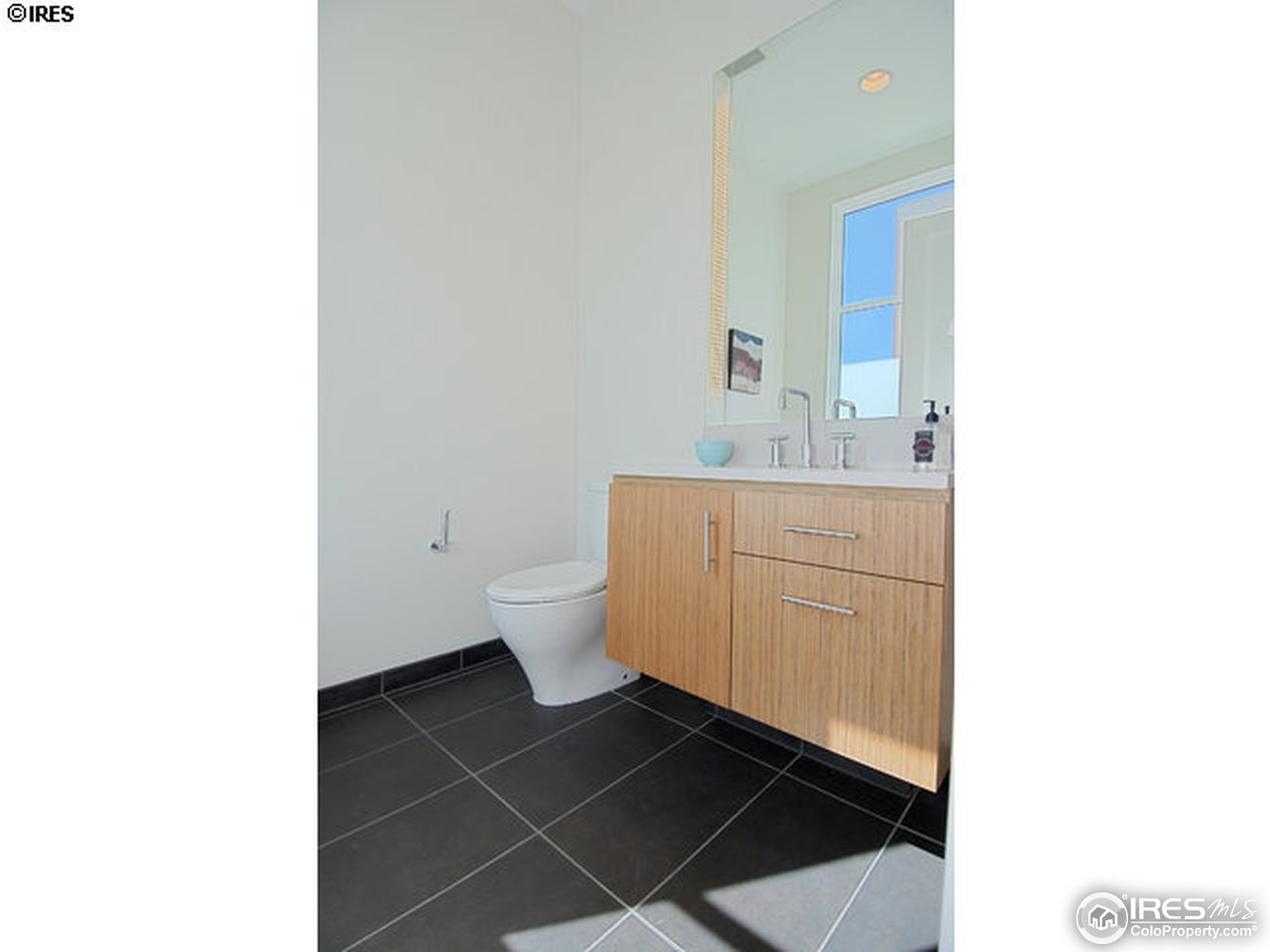 1655 Walnut Street, Unit 305 Boulder, CO 80302 - Photo 20 of 25 a bathroom with a sink a toilet and a mirror