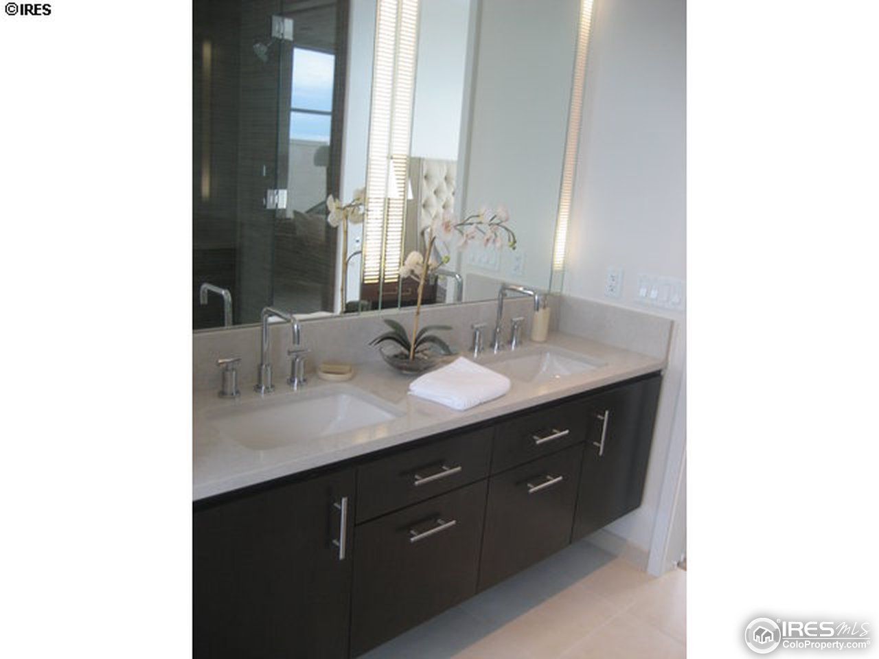 1655 Walnut Street, Unit 305 Boulder, CO 80302 - Photo 9 of 25 a bathroom with a double vanity sink and a mirror