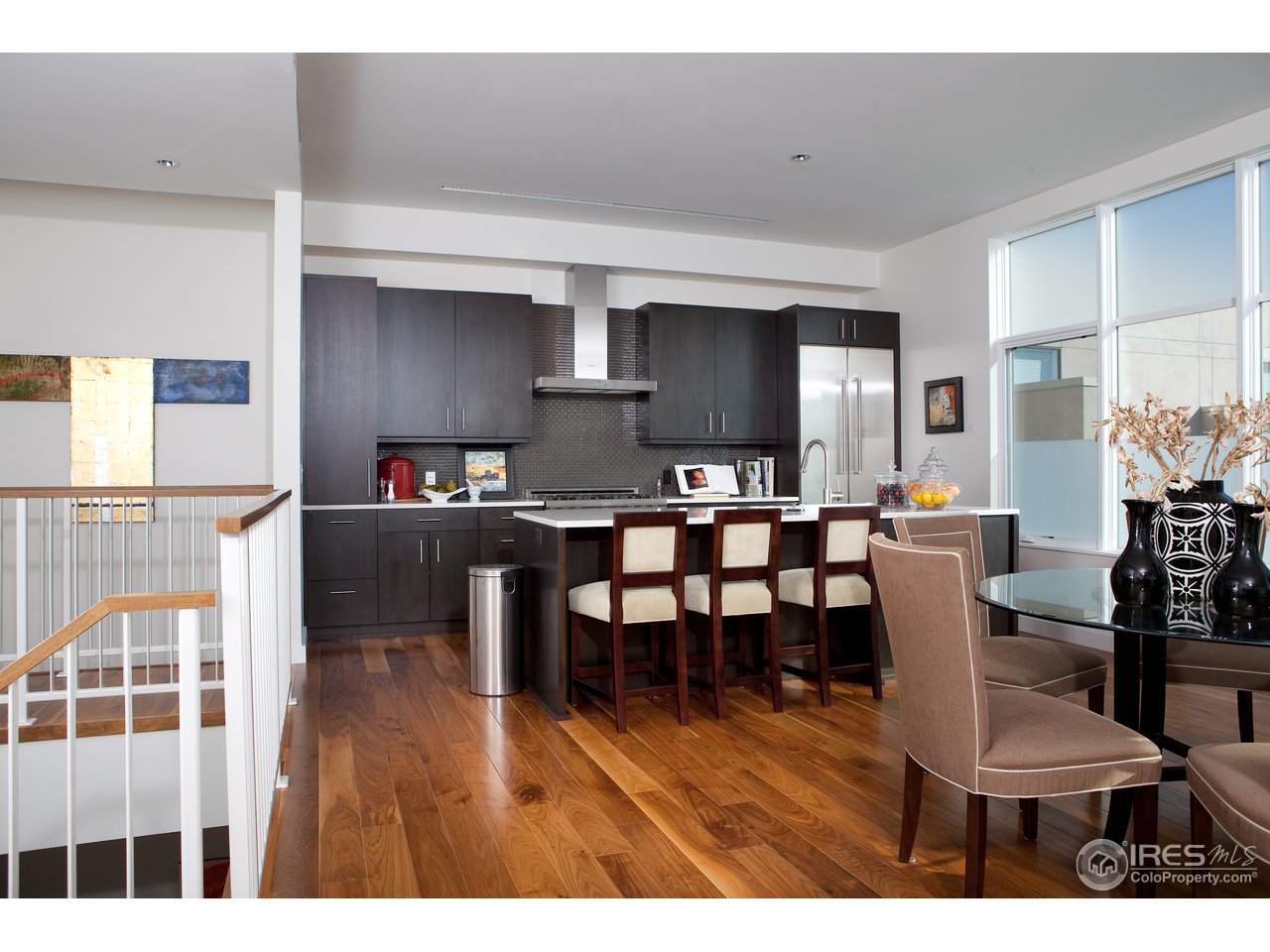 1655 Walnut Street, Unit 305 Boulder, CO 80302 - Photo 10 of 25 a living room with stainless steel appliances kitchen island granite countertop furniture and a wooden floor