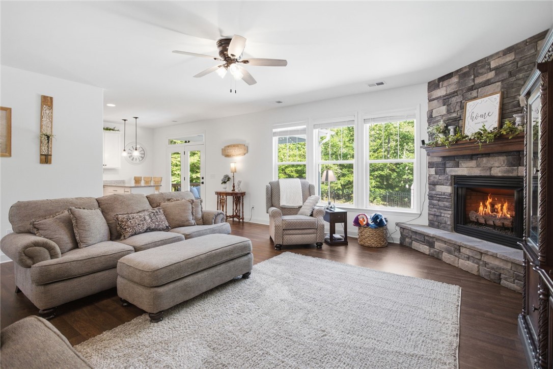 525 16th Circle Walhalla, SC 29691 - Photo 17 of 50 This inviting space features a cozy fireplace and expansive windows, perfect for relaxation and everyday living.