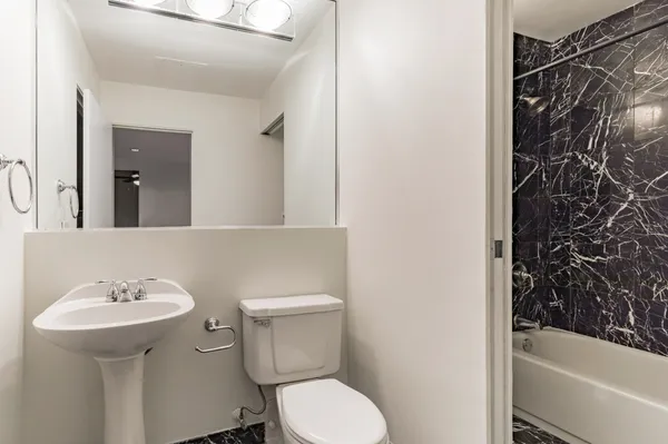 a bathroom with a sink toilet and shower