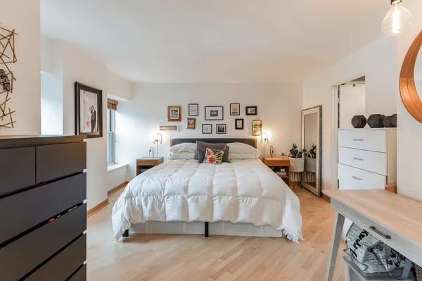 a bed room with a bed and a dresser