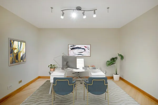 a view of a dining room with a table and chairs
