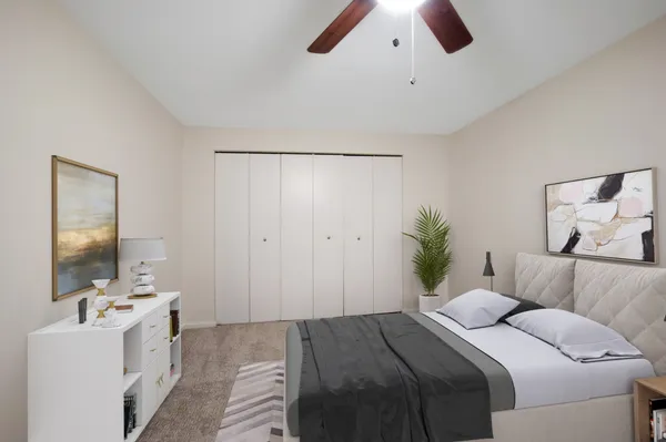 a bedroom with a bed and a chandelier