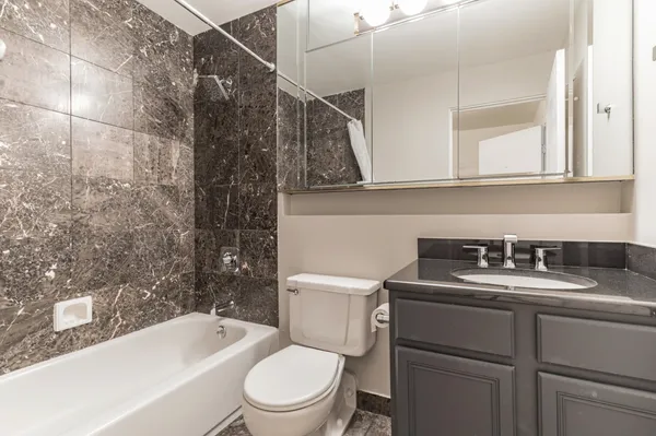 a bathroom with a sink a toilet and bathtub