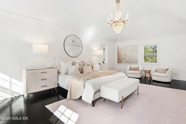 a bedroom with bed and a chandelier