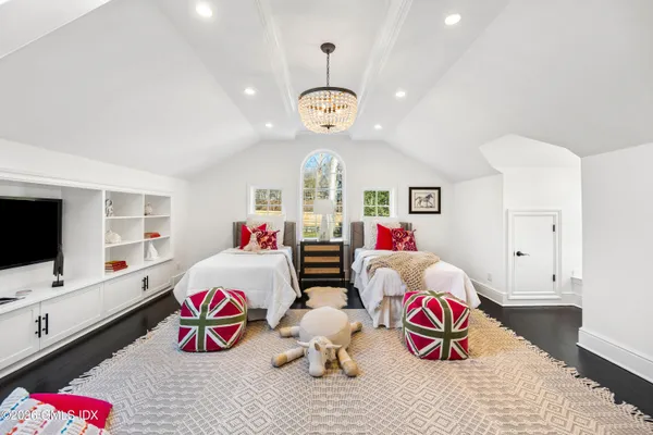 a bedroom with two beds and a window