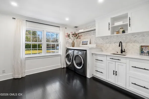 a view of a kitchen with sink washer and dryer