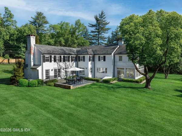 a front view of house with yard and outdoor seating