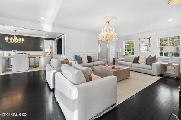 a living room with furniture and a chandelier