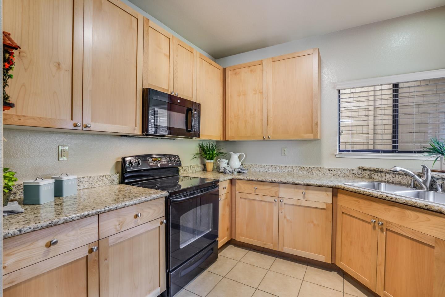 174 Copper Ridge Road San Ramon, CA 94582 - Photo 18 of 29 a kitchen with granite countertop cabinets stainless steel appliances a sink and a window