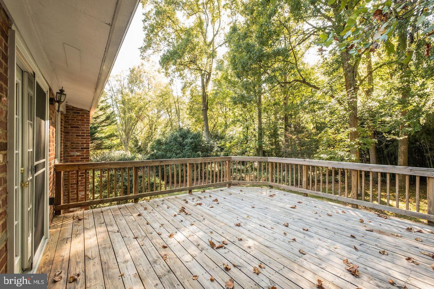 6710 Persimmon Tree Road Bethesda, MD 20817 - Photo 11 of 39 a balcony with wooden floor and fence