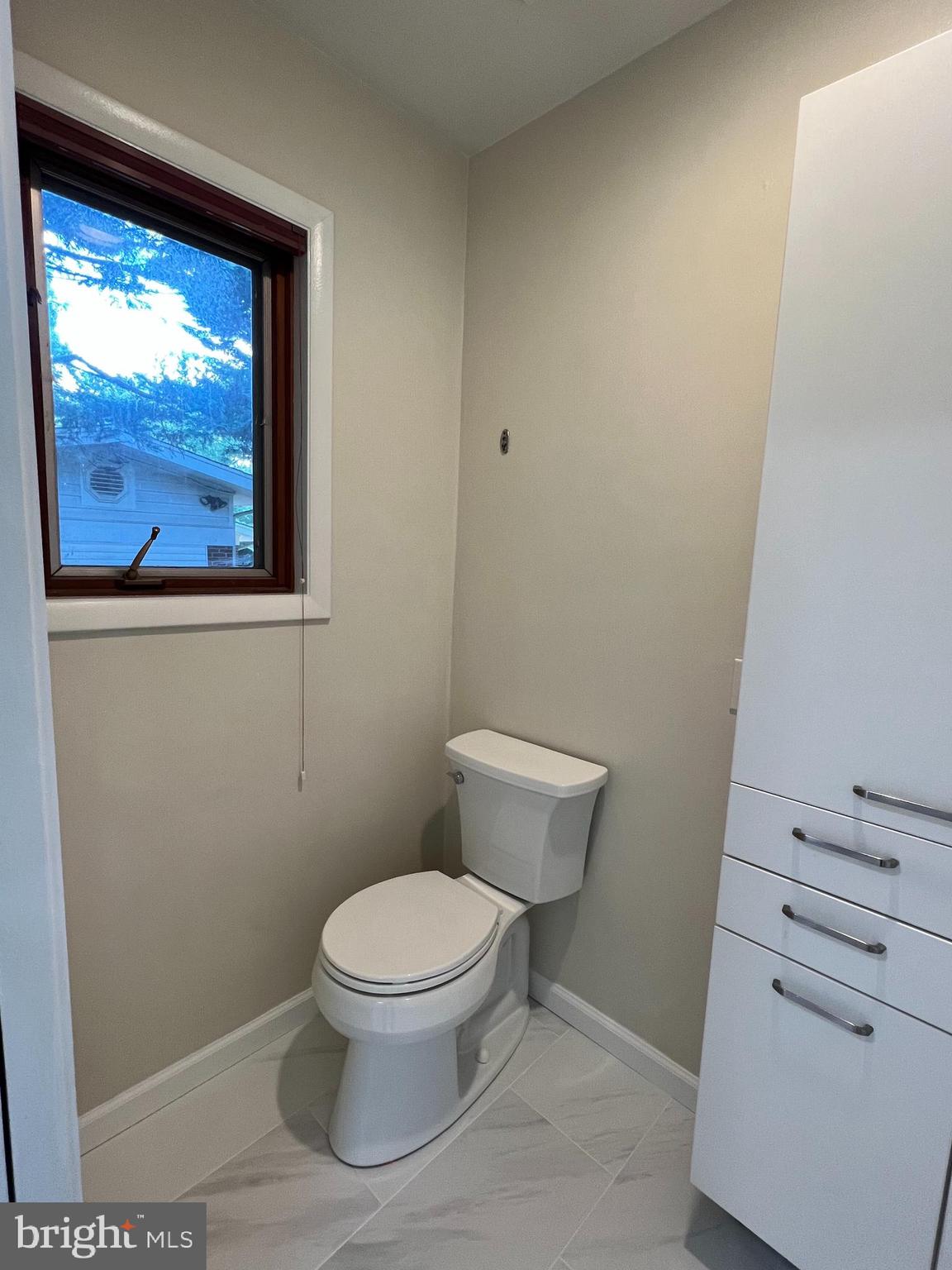 6710 Persimmon Tree Road Bethesda, MD 20817 - Photo 19 of 39 a white toilet sitting next to a window