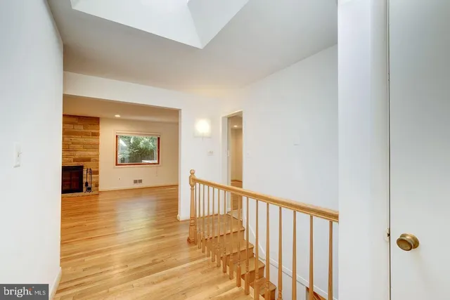 a view of a hallway view with wooden floor and staircase