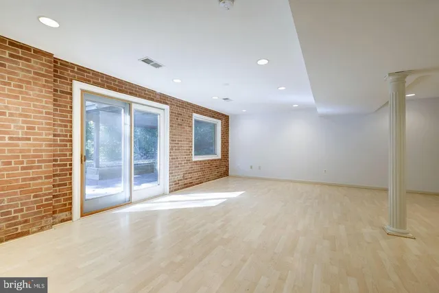 a view of an empty room with glass door