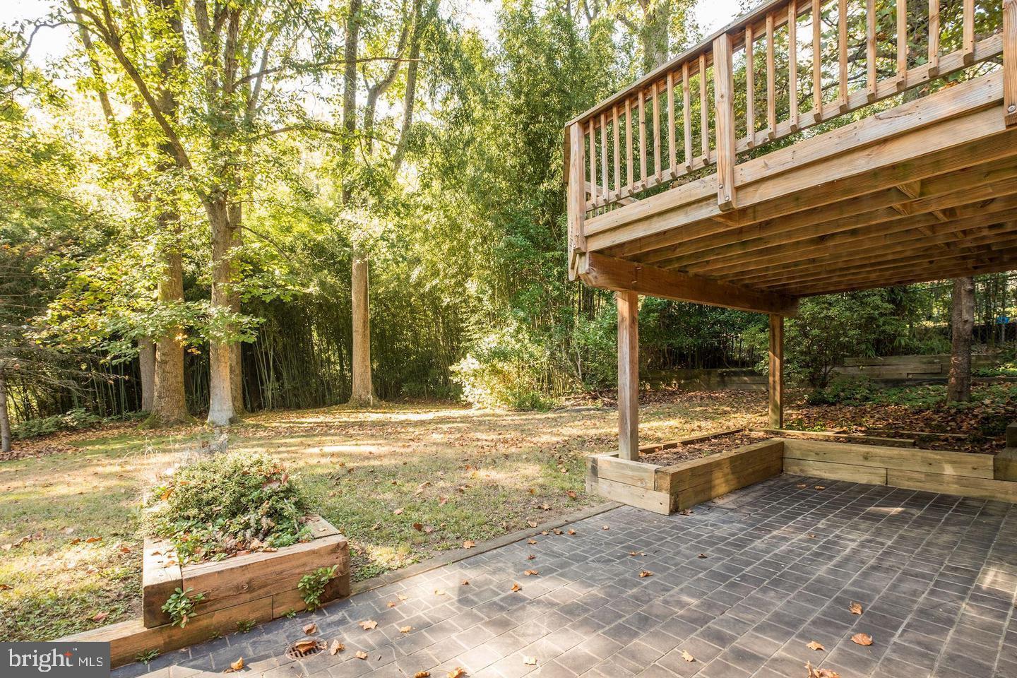 6710 Persimmon Tree Road Bethesda, MD 20817 - Photo 33 of 39 a backyard of a house with table and chairs