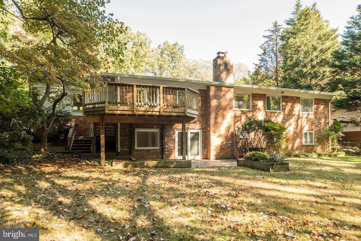 6710 Persimmon Tree Road Bethesda, MD 20817 - Photo 35 of 39 a front view of a house with a garden