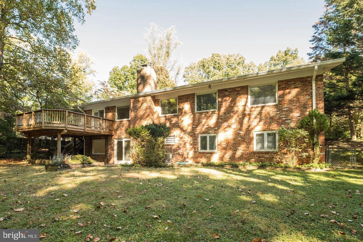 6710 Persimmon Tree Road Bethesda, MD 20817 - Photo 36 of 39 a front view of a house with a yard