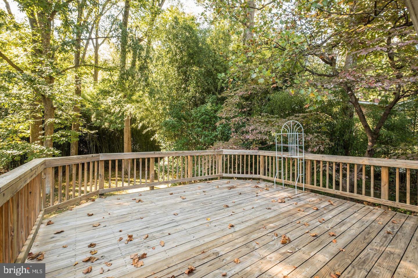 6710 Persimmon Tree Road Bethesda, MD 20817 - Photo 10 of 39 a balcony with wooden floor and fence