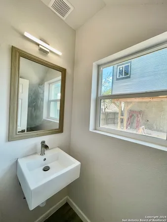 a white toilet sitting next to a window