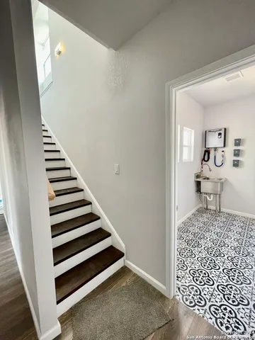 a view of a hallway with wooden floor and entryway