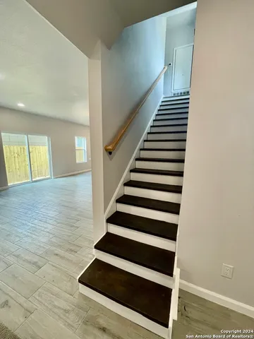 a view of kitchen and hall with wooden floor