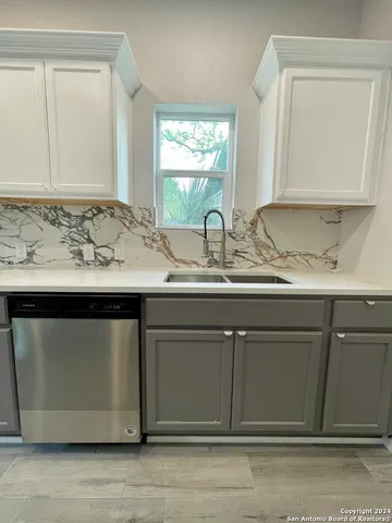 a kitchen with stainless steel appliances kitchen island granite countertop a stove a sink and a microwave