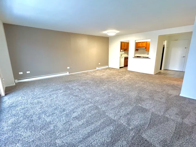 a view of a livingroom with wooden floor and a fireplace