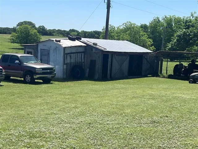 a view of dirt road with a building in the background